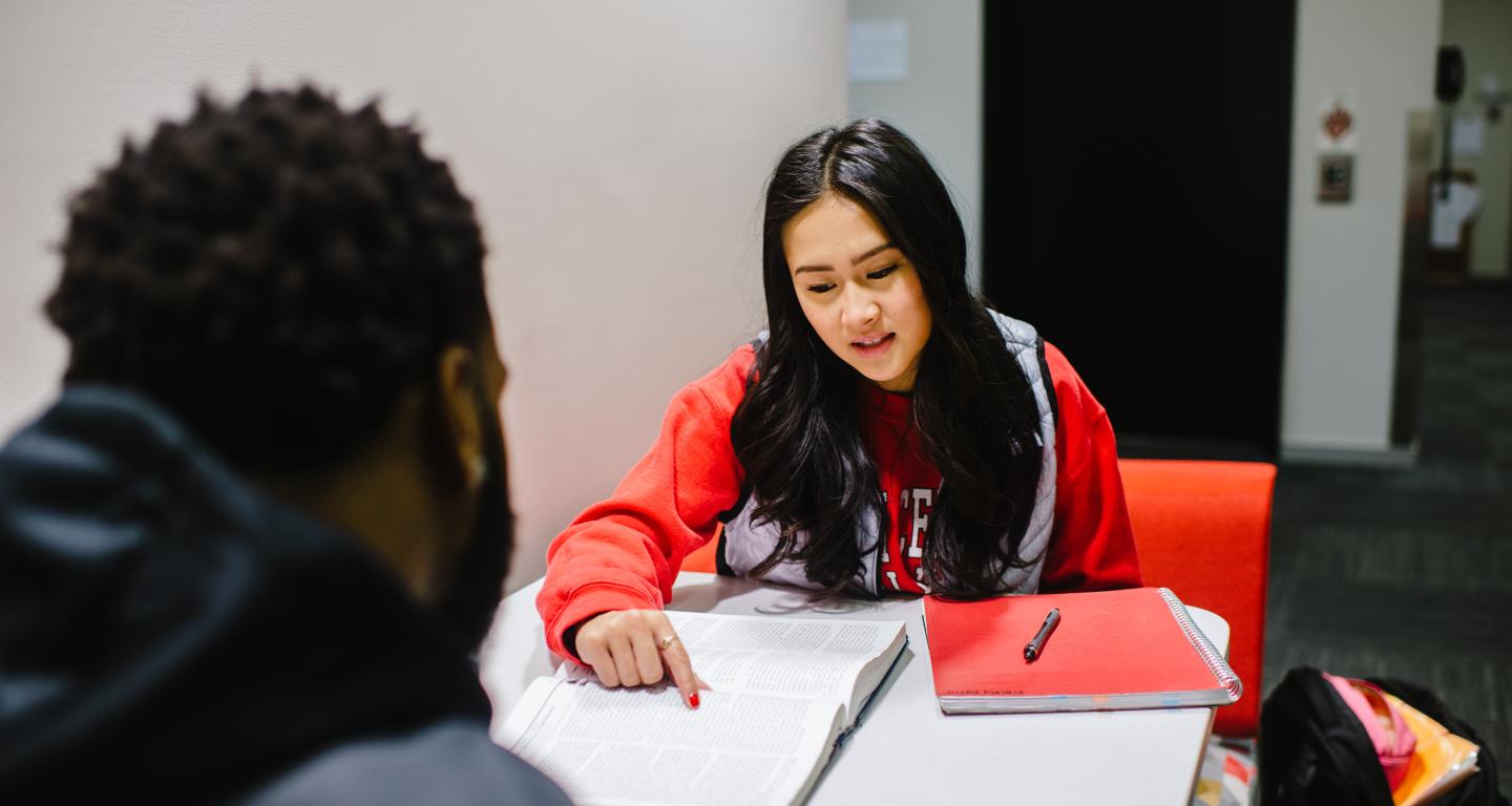 students looking at notes, studying