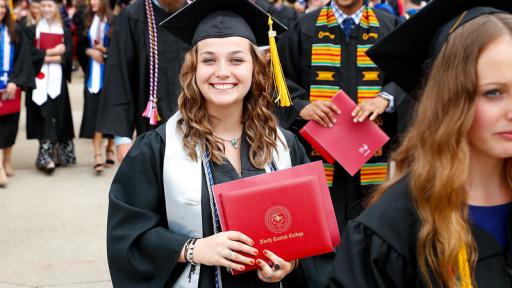Student at graduation with honors cords
