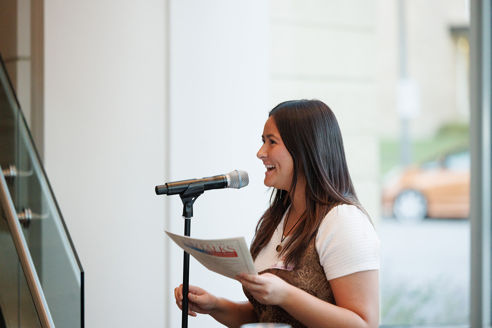 A student talking into a microphone at the Tay Talks event.