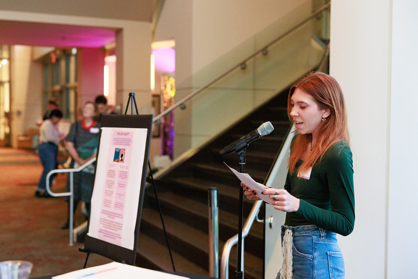 A student talking into a microphone at the Tay Talks event.