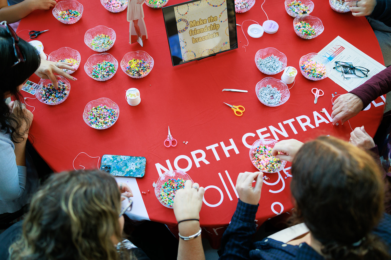 People making friendship bracelets at the Tay Talks event.