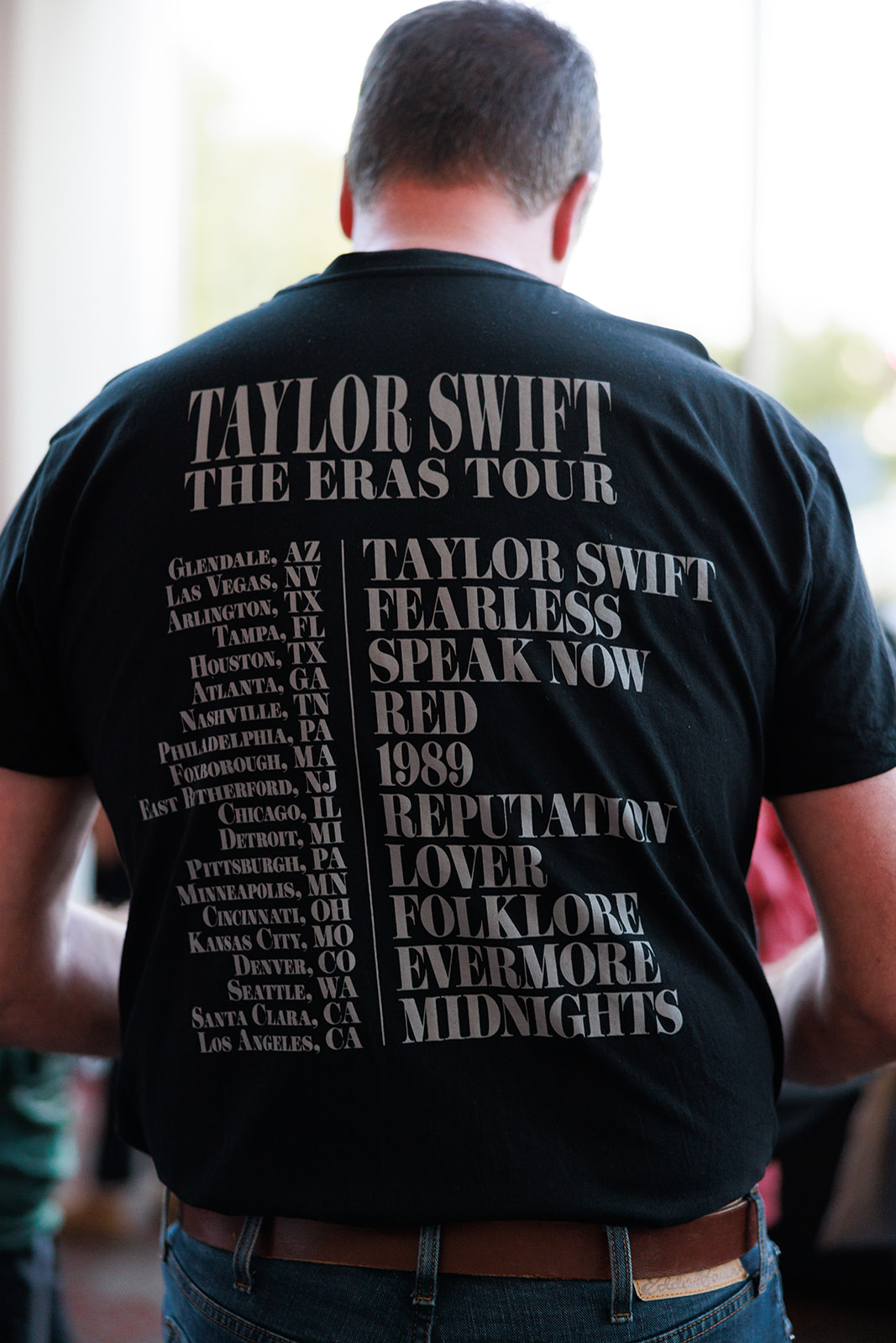 A man wearing a Taylor Swift t-shirt.