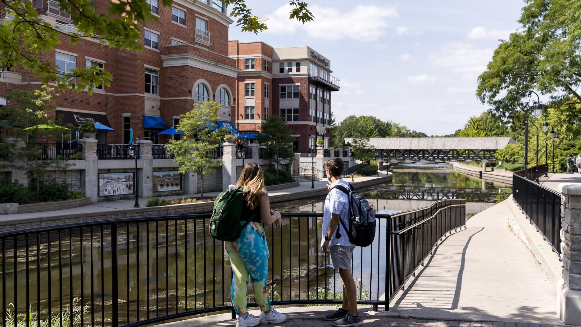 Students walking along Naperville Riverwalk