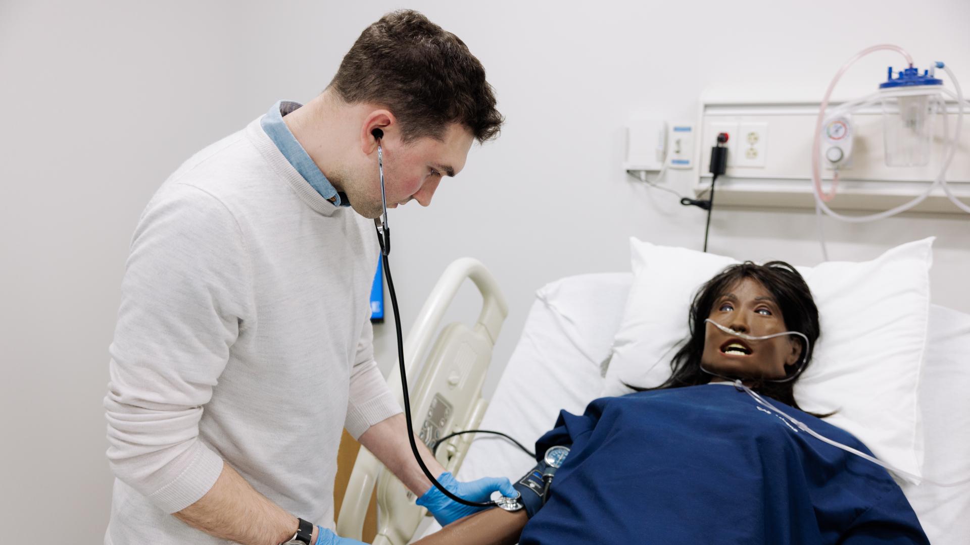 Nursing student with mannequin patient