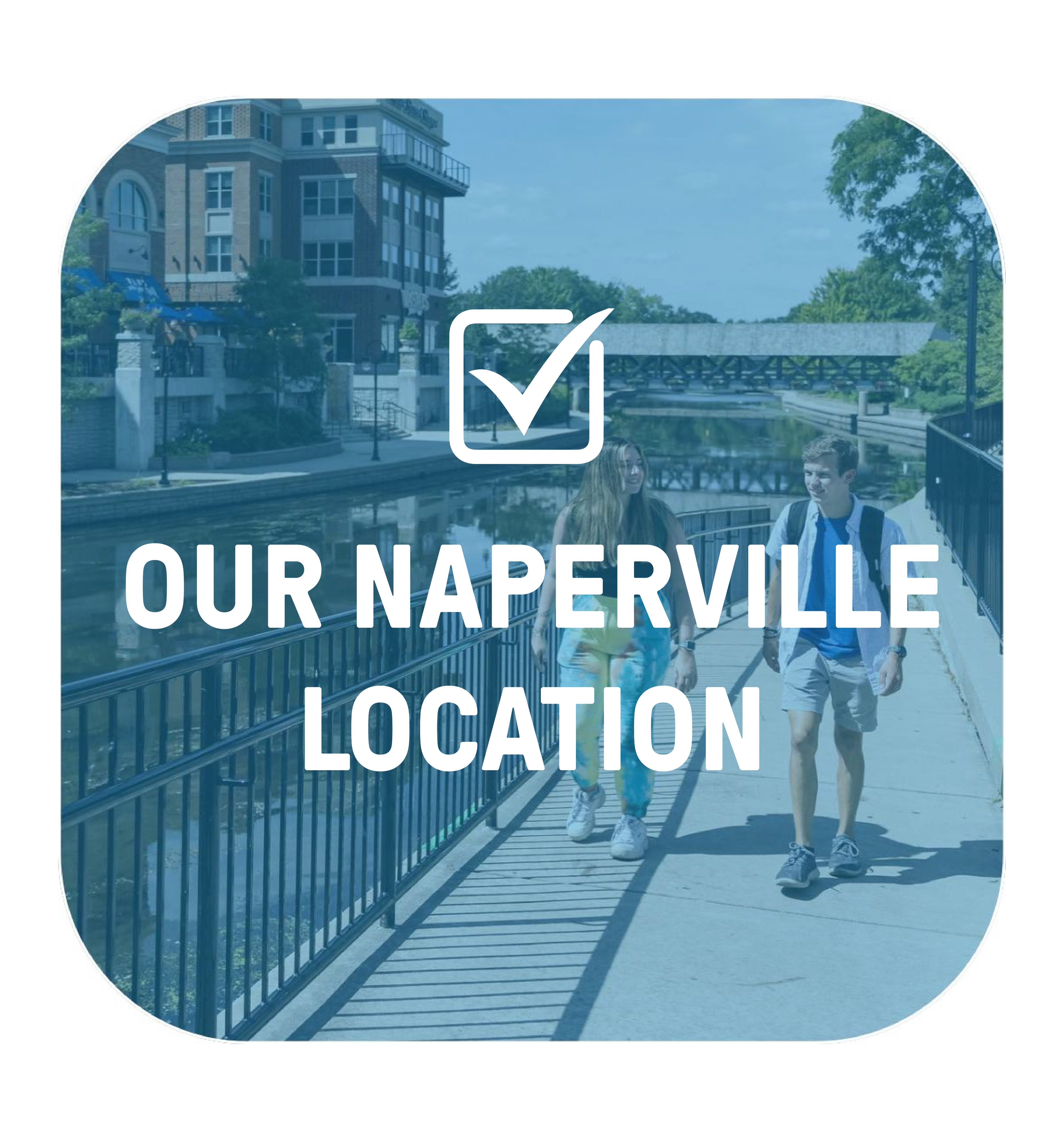 Two students walking along the Naperville Riverwalk on a dark blue overlay