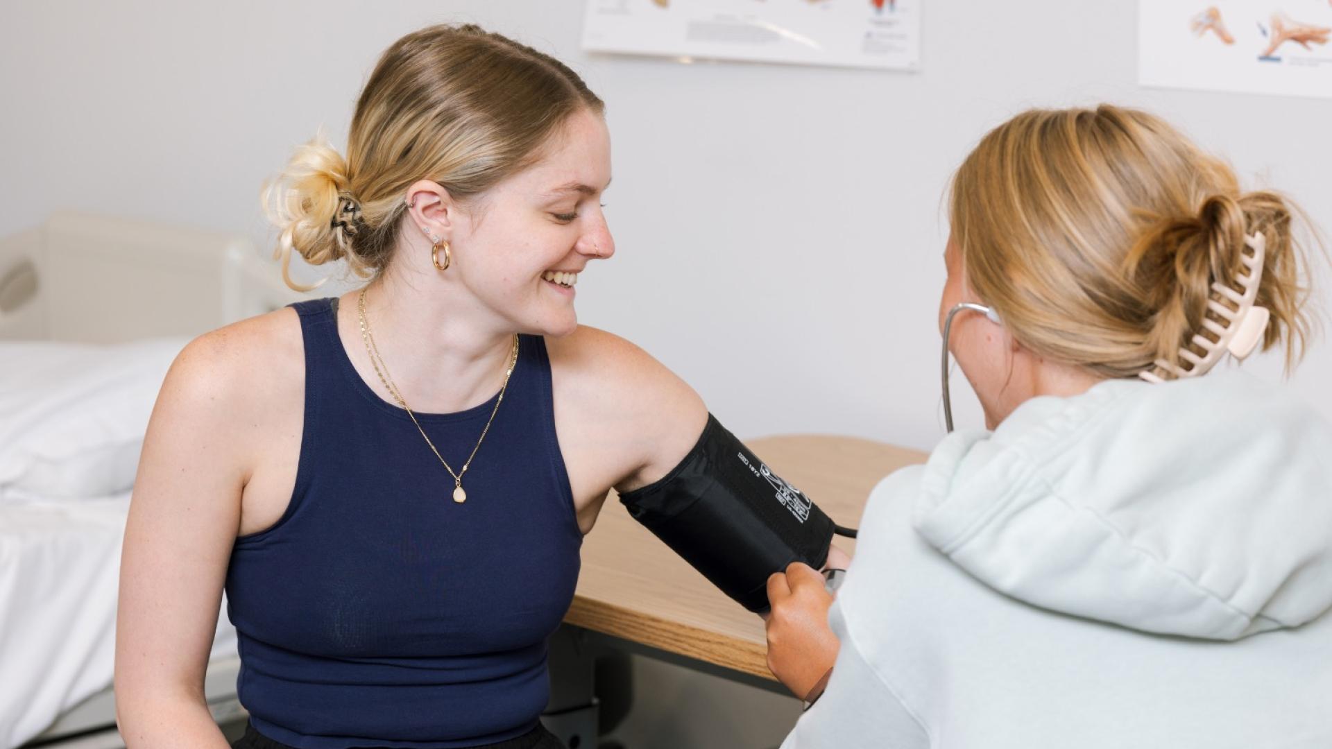 Student nurse taking blood pressure