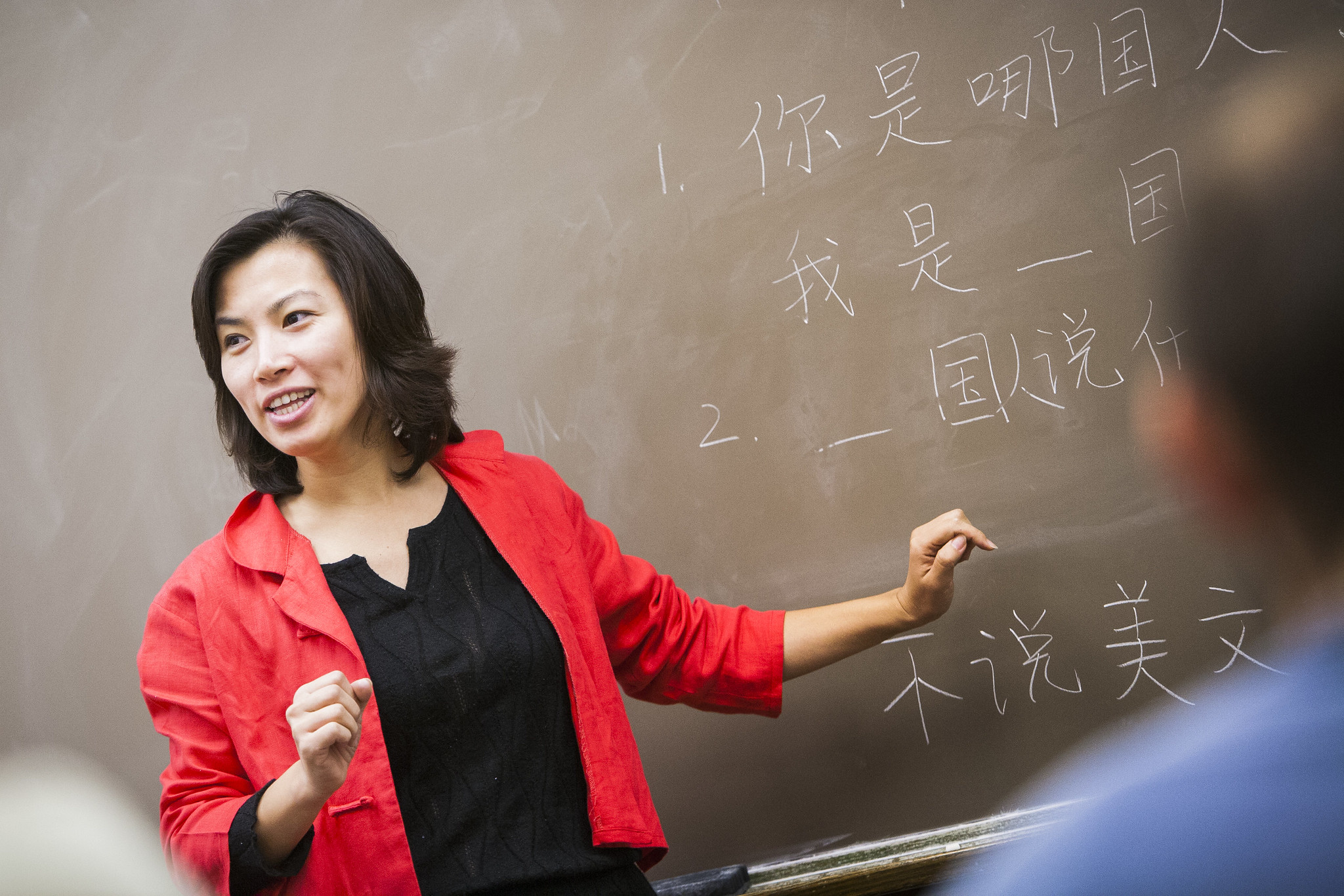 Teacher speaking in front of blackboard