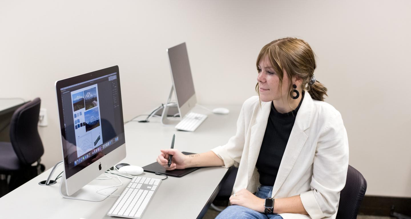 A North Central college graphic design student working on a project.