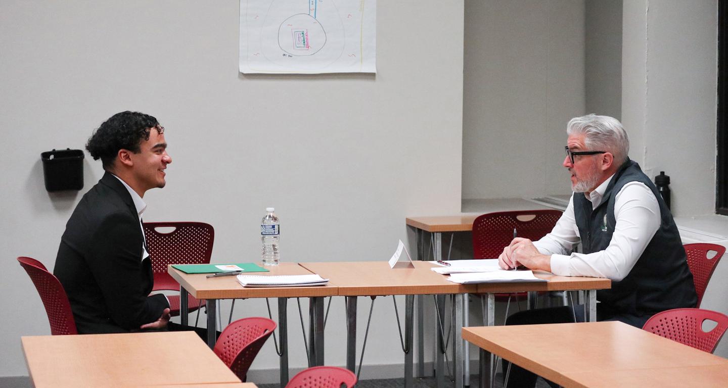 A North Central College student conducts a mock interview with an alumnus.