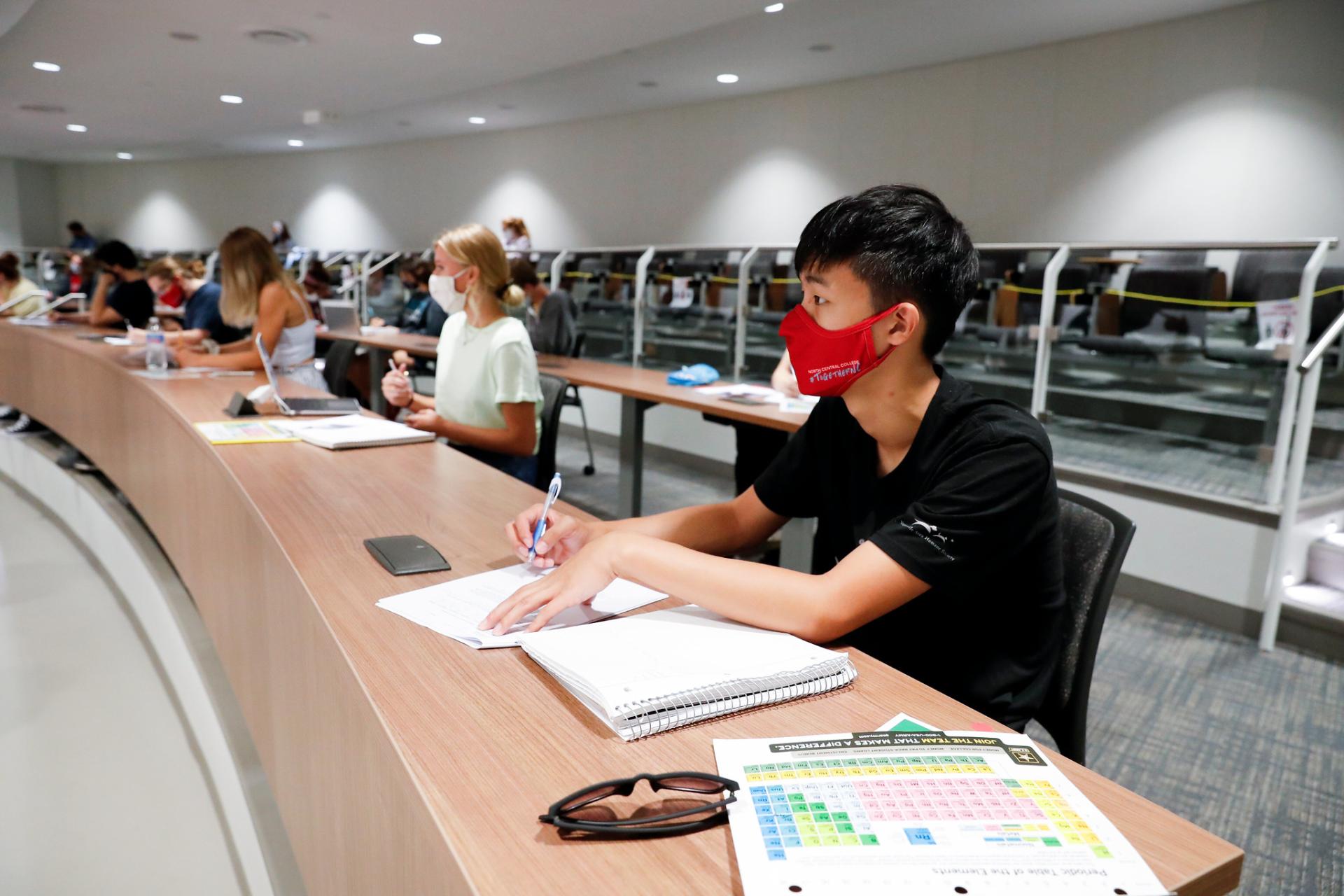 Lecture hall of North Central College students wearing facial masks due to COVID-19