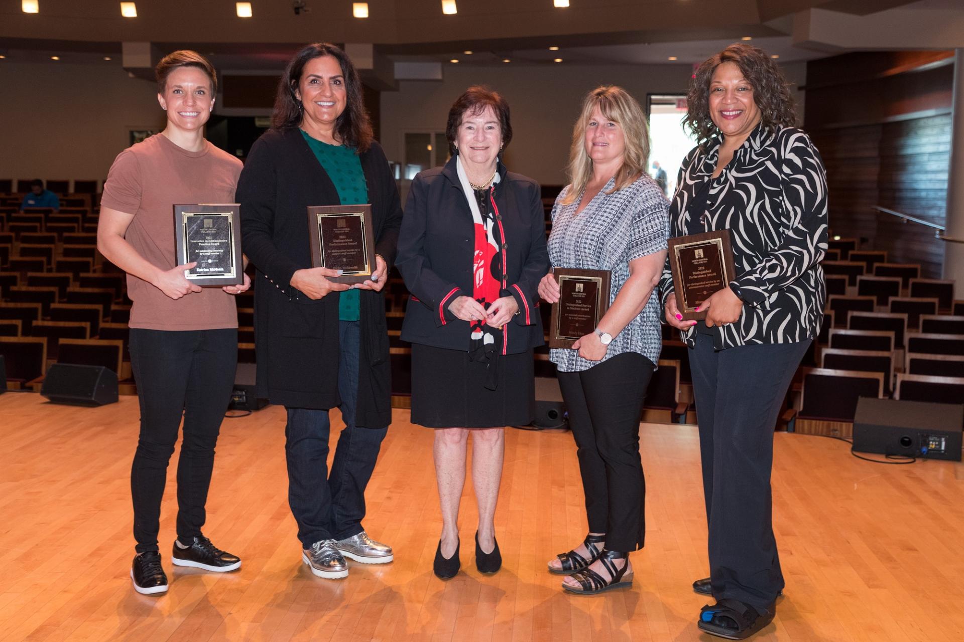 Interim President Donna Carroll with the staff award winners.