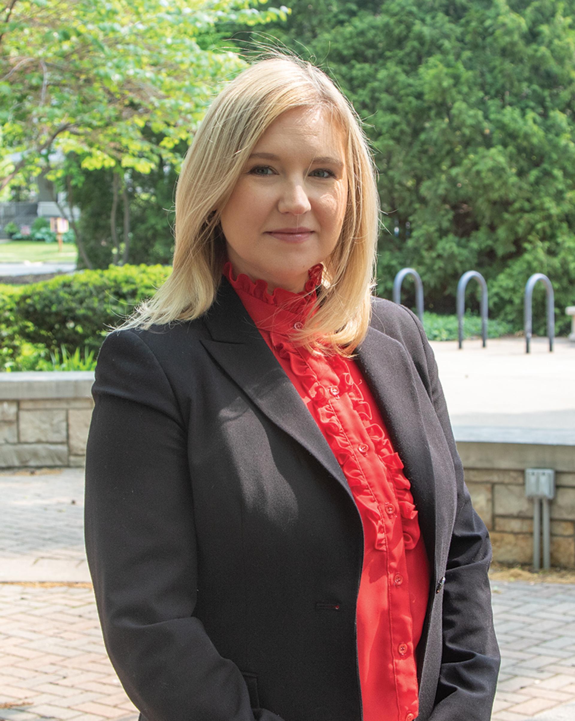 Dr. Agnieszka "Aggie" Hanni, poses for a headshot in Old Main Plaza