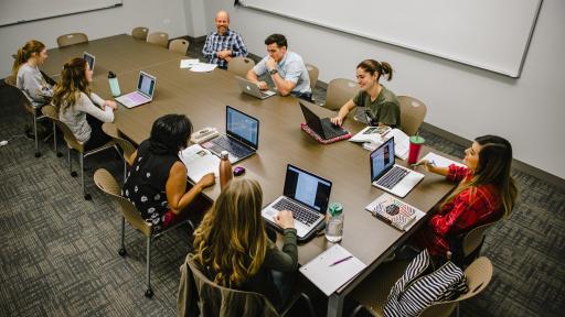 Students having a discussion at a table.