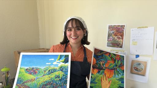 Andrea Peguero Gonzalez displays two of her paintings