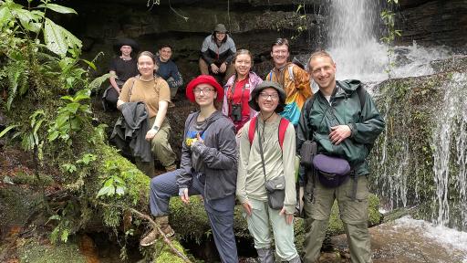 North Central College students standing in front of a waterfall.