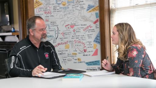 A North Central College professor and student having a discussion.