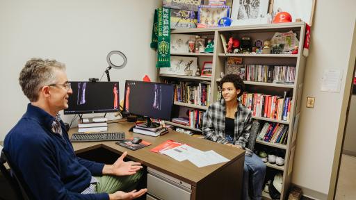 A North Central College student meeting with a professor.