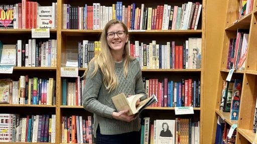 Elizabeth Kulisek ’17 is posing for a photo in a book store.