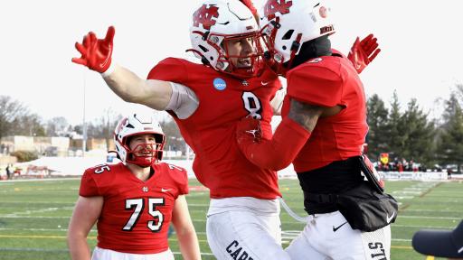 Three members of the Cardinal football team are celebrating on the field.