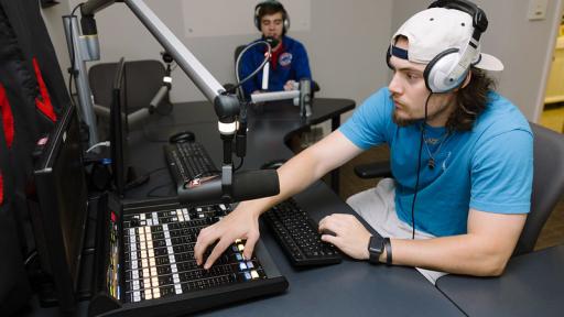 Student behind the scenes at the WONC radio station