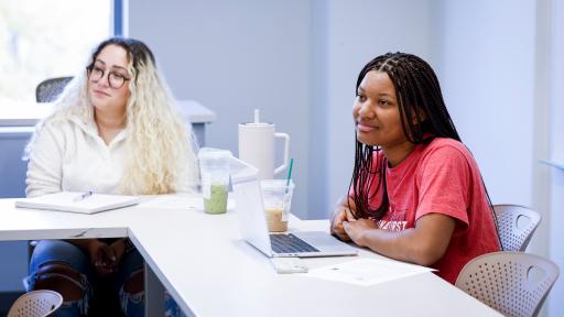 two students sitting in a classroom during a lecture